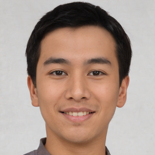 Joyful asian young-adult male with short  black hair and brown eyes