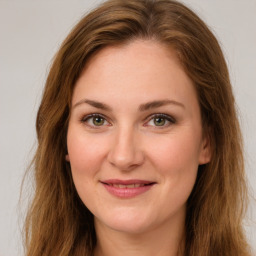 Joyful white young-adult female with long  brown hair and green eyes