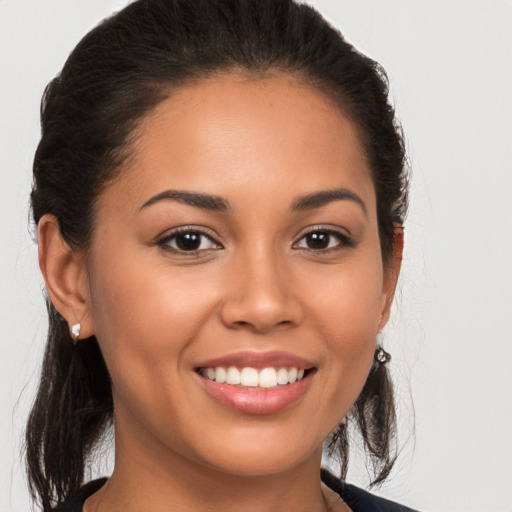 Joyful white young-adult female with long  brown hair and brown eyes