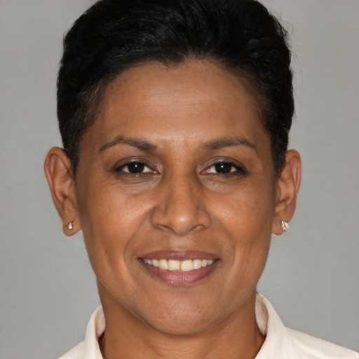 Joyful latino adult female with short  brown hair and brown eyes