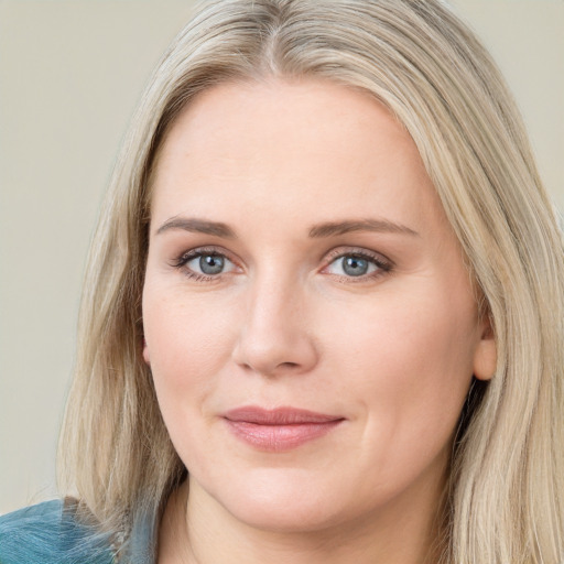 Joyful white young-adult female with long  brown hair and blue eyes