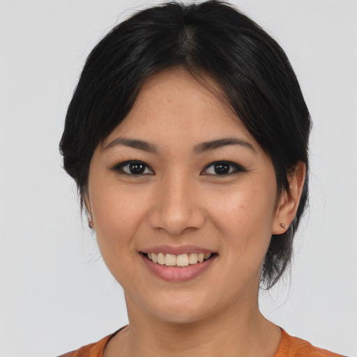 Joyful asian young-adult female with medium  black hair and brown eyes