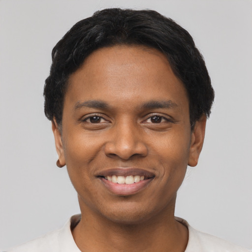 Joyful black young-adult male with short  black hair and brown eyes