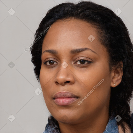 Joyful black young-adult female with long  black hair and brown eyes