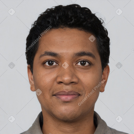 Joyful black young-adult male with short  black hair and brown eyes