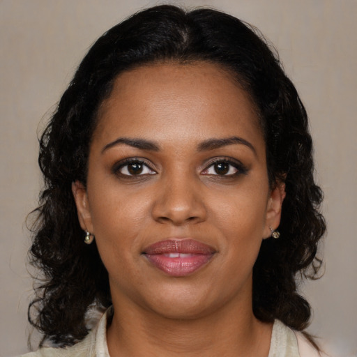Joyful black young-adult female with medium  black hair and brown eyes