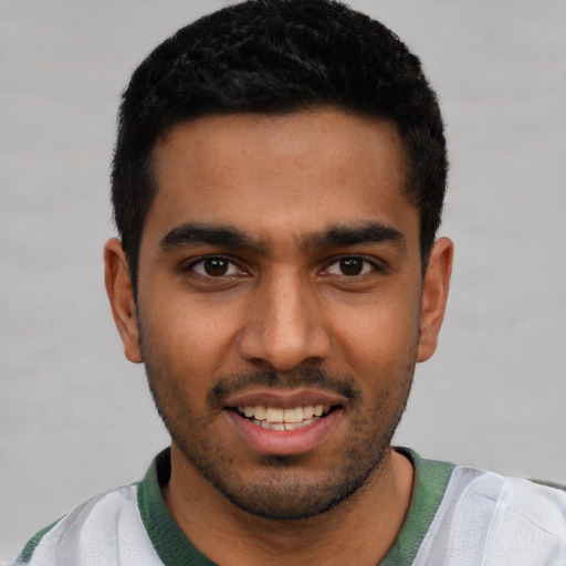 Joyful latino young-adult male with short  black hair and brown eyes