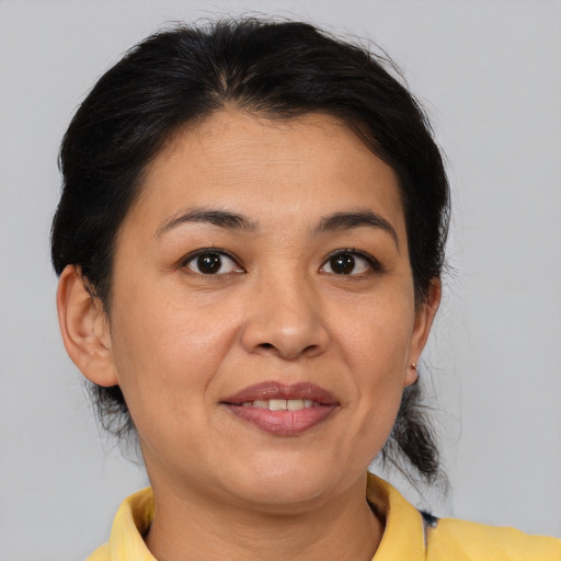 Joyful asian adult female with medium  brown hair and brown eyes