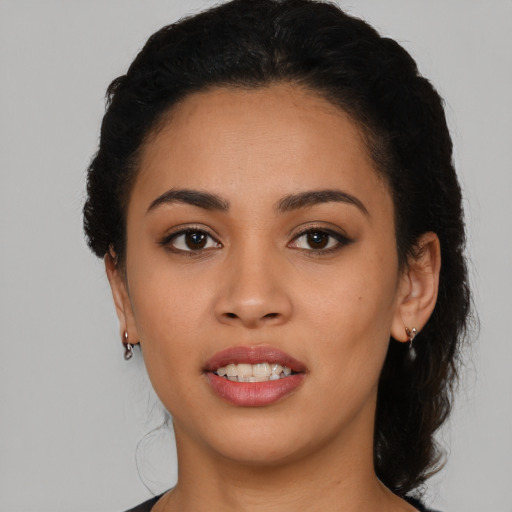 Joyful latino young-adult female with long  brown hair and brown eyes