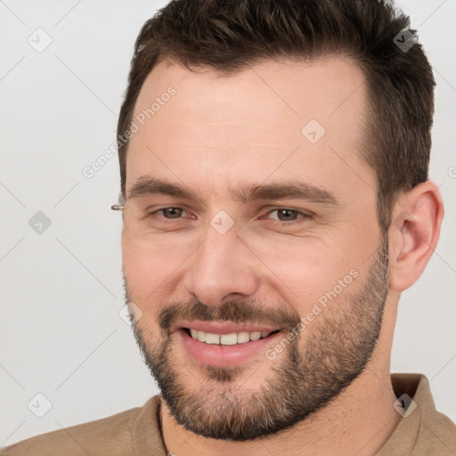 Joyful white adult male with short  brown hair and brown eyes