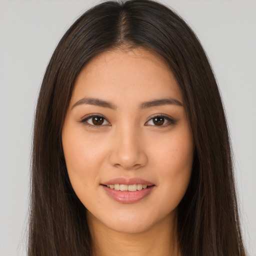Joyful white young-adult female with long  brown hair and brown eyes
