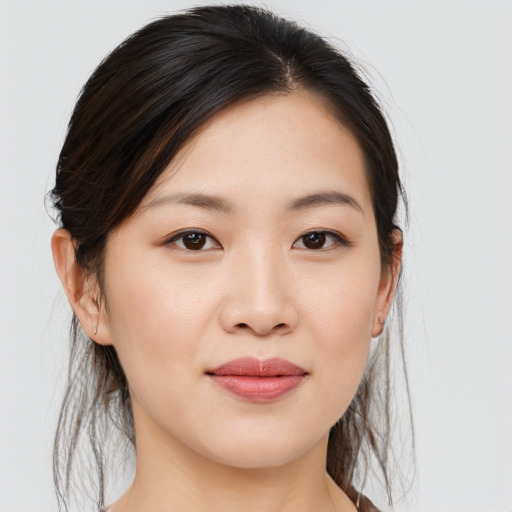 Joyful asian young-adult female with medium  brown hair and brown eyes
