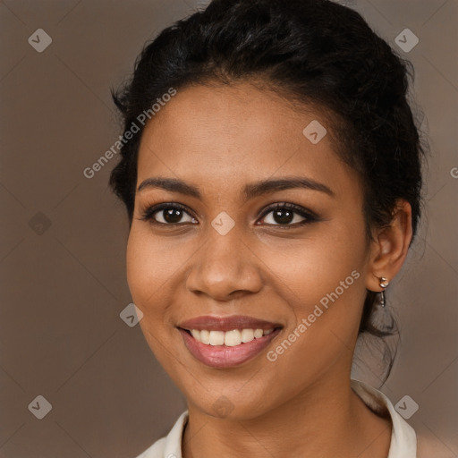 Joyful black young-adult female with long  brown hair and brown eyes