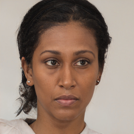 Neutral black young-adult female with medium  brown hair and brown eyes