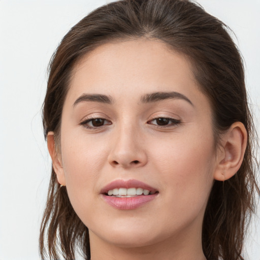 Joyful white young-adult female with long  brown hair and brown eyes