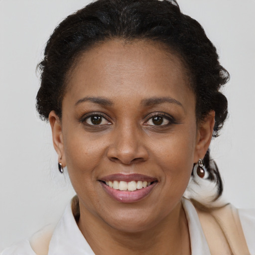 Joyful black young-adult female with medium  brown hair and brown eyes