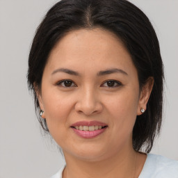 Joyful asian young-adult female with medium  brown hair and brown eyes