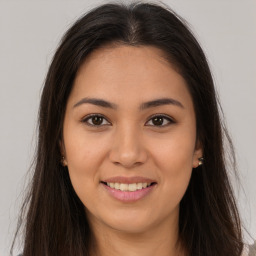 Joyful white young-adult female with long  brown hair and brown eyes