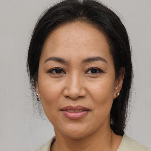 Joyful asian adult female with medium  brown hair and brown eyes