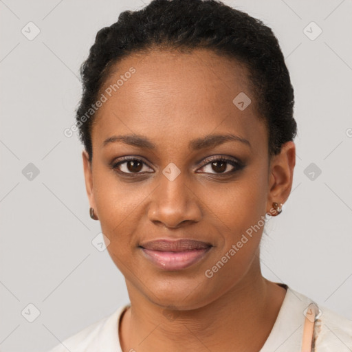 Joyful black young-adult female with short  black hair and brown eyes