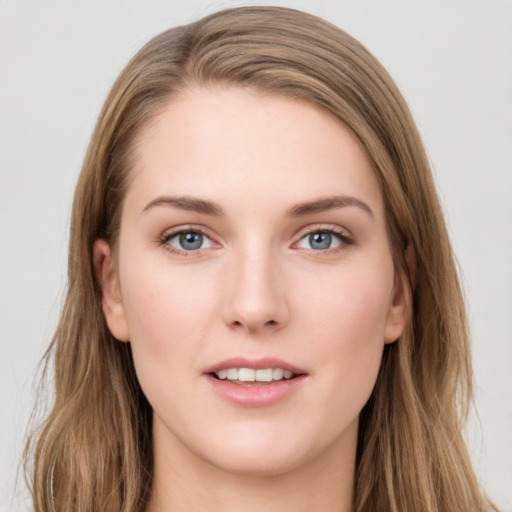 Joyful white young-adult female with long  brown hair and grey eyes