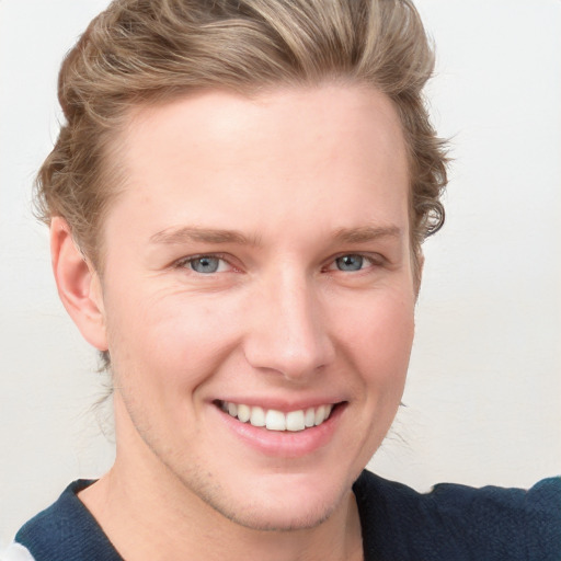 Joyful white young-adult male with short  brown hair and blue eyes