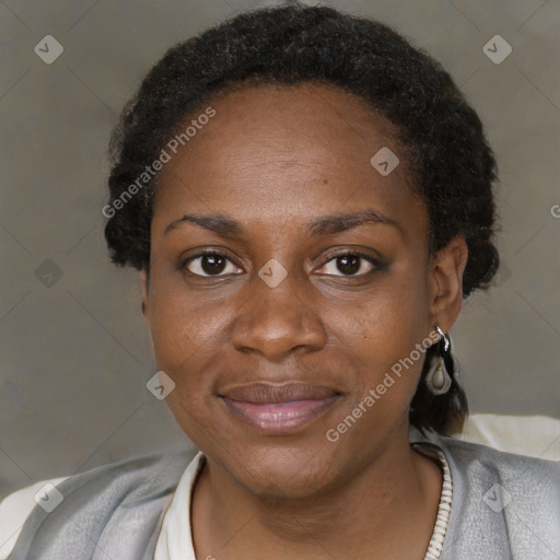 Joyful black adult female with short  brown hair and brown eyes