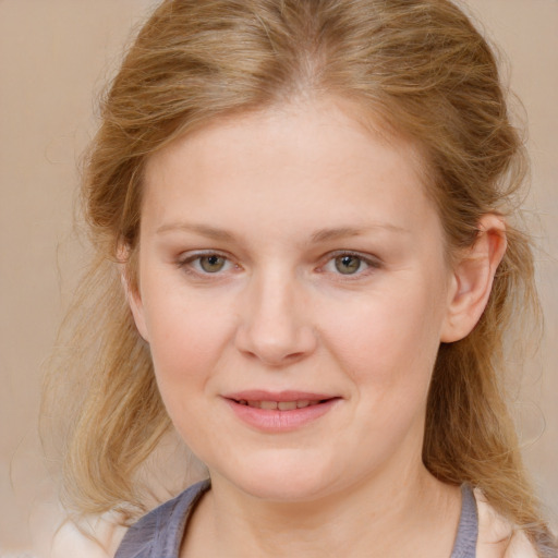 Joyful white young-adult female with medium  brown hair and blue eyes