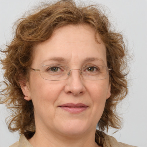 Joyful white adult female with medium  brown hair and green eyes