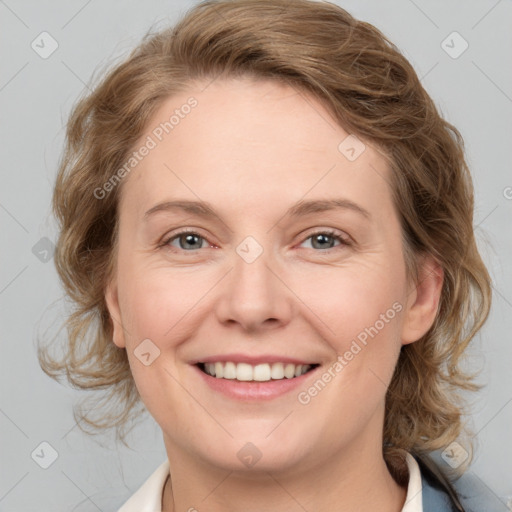 Joyful white adult female with medium  brown hair and blue eyes