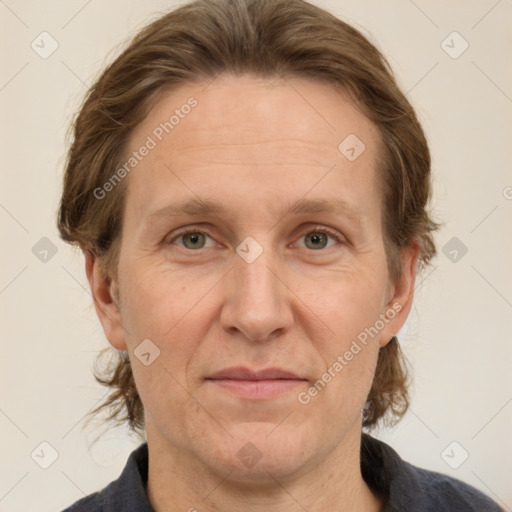 Joyful white adult female with medium  brown hair and grey eyes