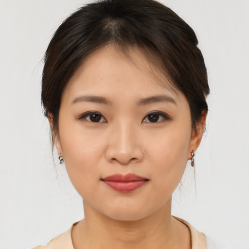 Joyful asian young-adult female with medium  brown hair and brown eyes