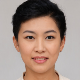 Joyful asian young-adult female with short  black hair and brown eyes