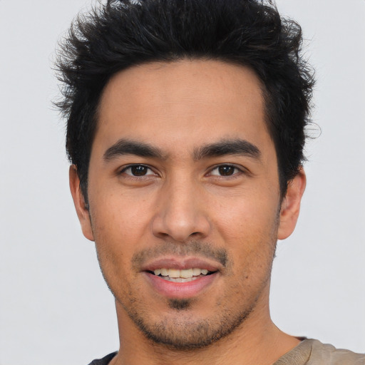 Joyful asian young-adult male with short  black hair and brown eyes