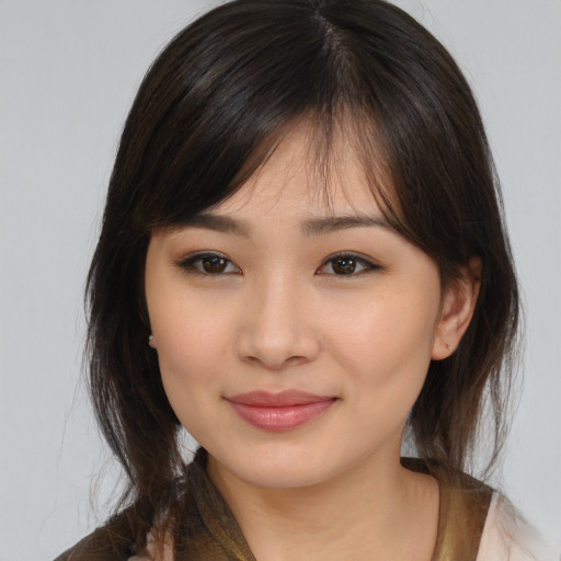Joyful asian young-adult female with medium  brown hair and brown eyes