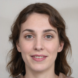 Joyful white young-adult female with medium  brown hair and green eyes