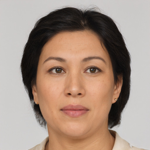 Joyful asian adult female with medium  brown hair and brown eyes
