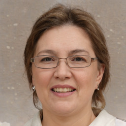 Joyful white adult female with medium  brown hair and blue eyes