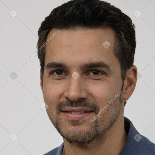 Joyful white young-adult male with short  black hair and brown eyes