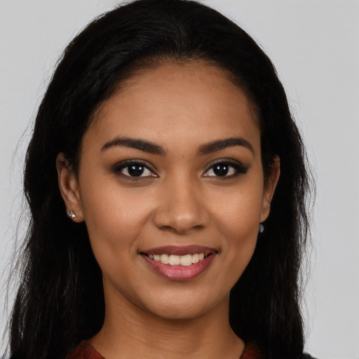 Joyful latino young-adult female with long  black hair and brown eyes