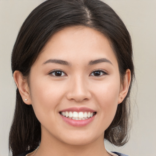 Joyful white young-adult female with medium  brown hair and brown eyes