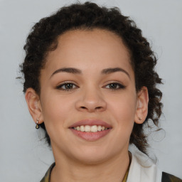 Joyful latino young-adult female with medium  brown hair and brown eyes