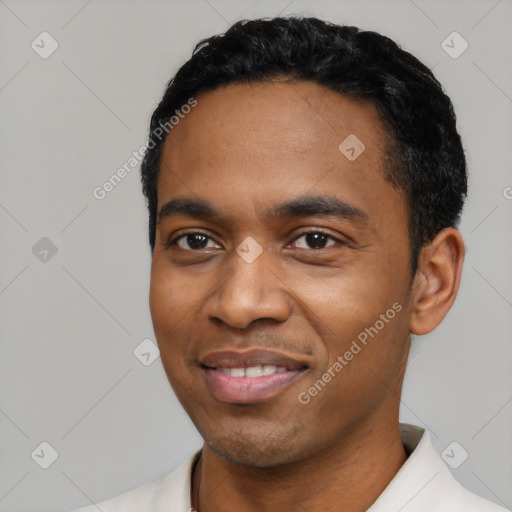 Joyful black young-adult male with short  black hair and brown eyes