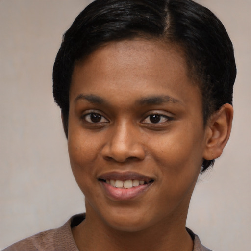 Joyful black young-adult female with short  black hair and brown eyes