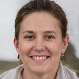 Joyful white adult female with short  brown hair and grey eyes