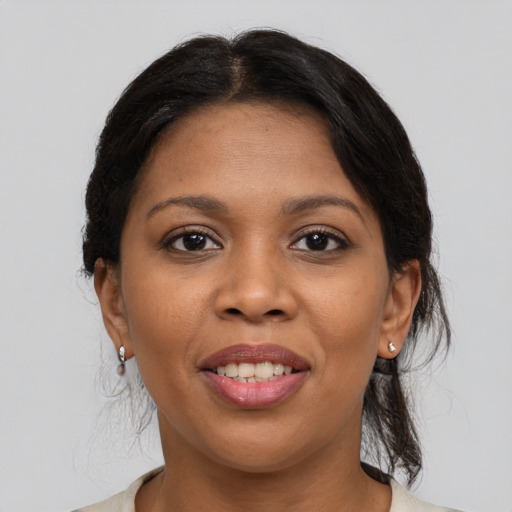 Joyful latino young-adult female with medium  brown hair and brown eyes