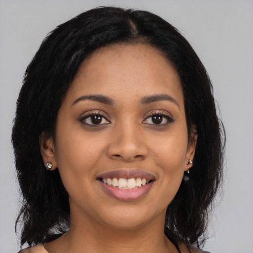 Joyful latino young-adult female with long  black hair and brown eyes