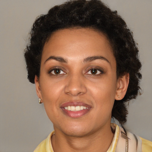 Joyful latino young-adult female with short  brown hair and brown eyes