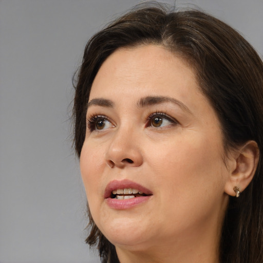 Joyful white adult female with medium  brown hair and brown eyes