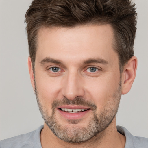 Joyful white adult male with short  brown hair and brown eyes